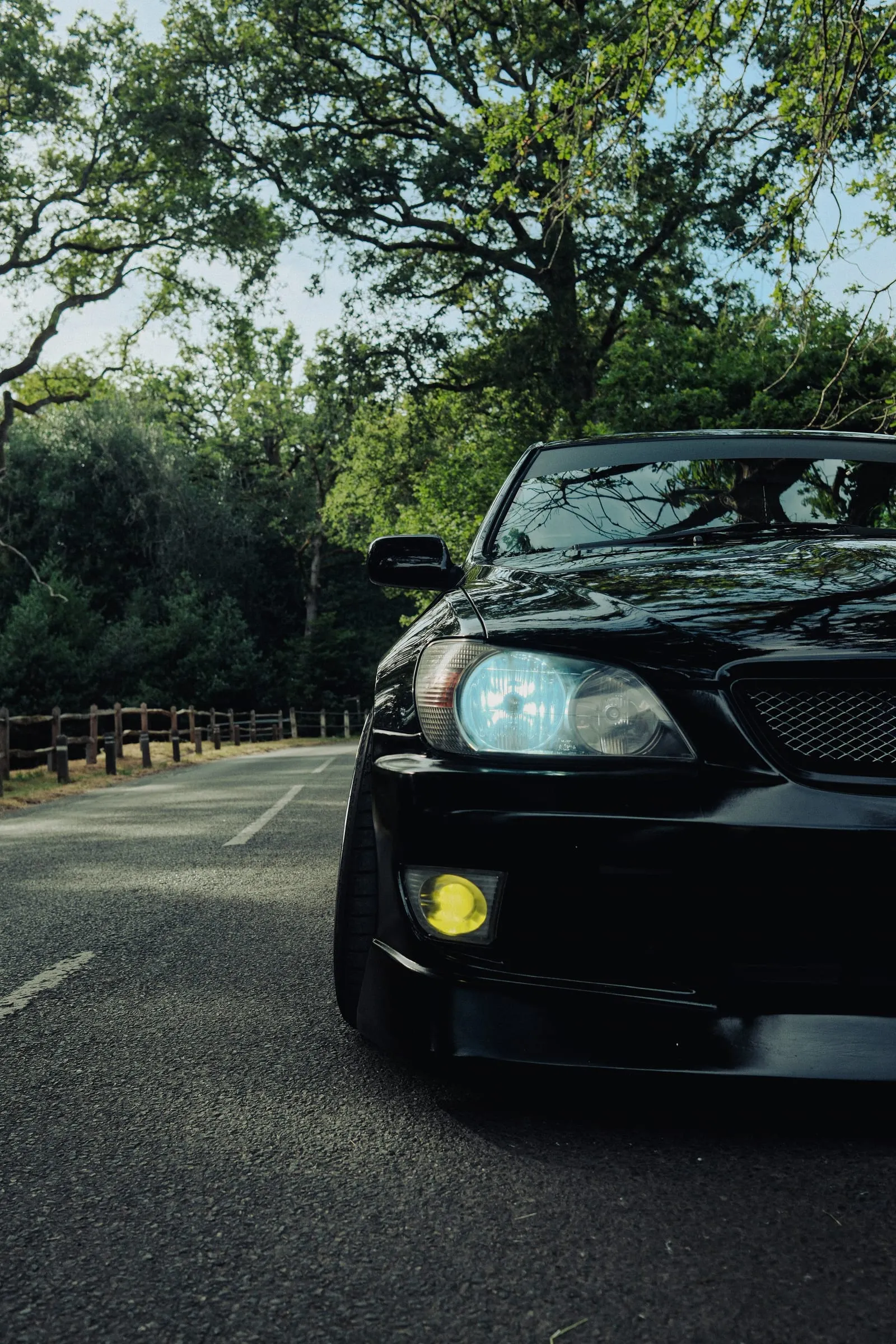 The car's nose pushing into the frame on an empty road.