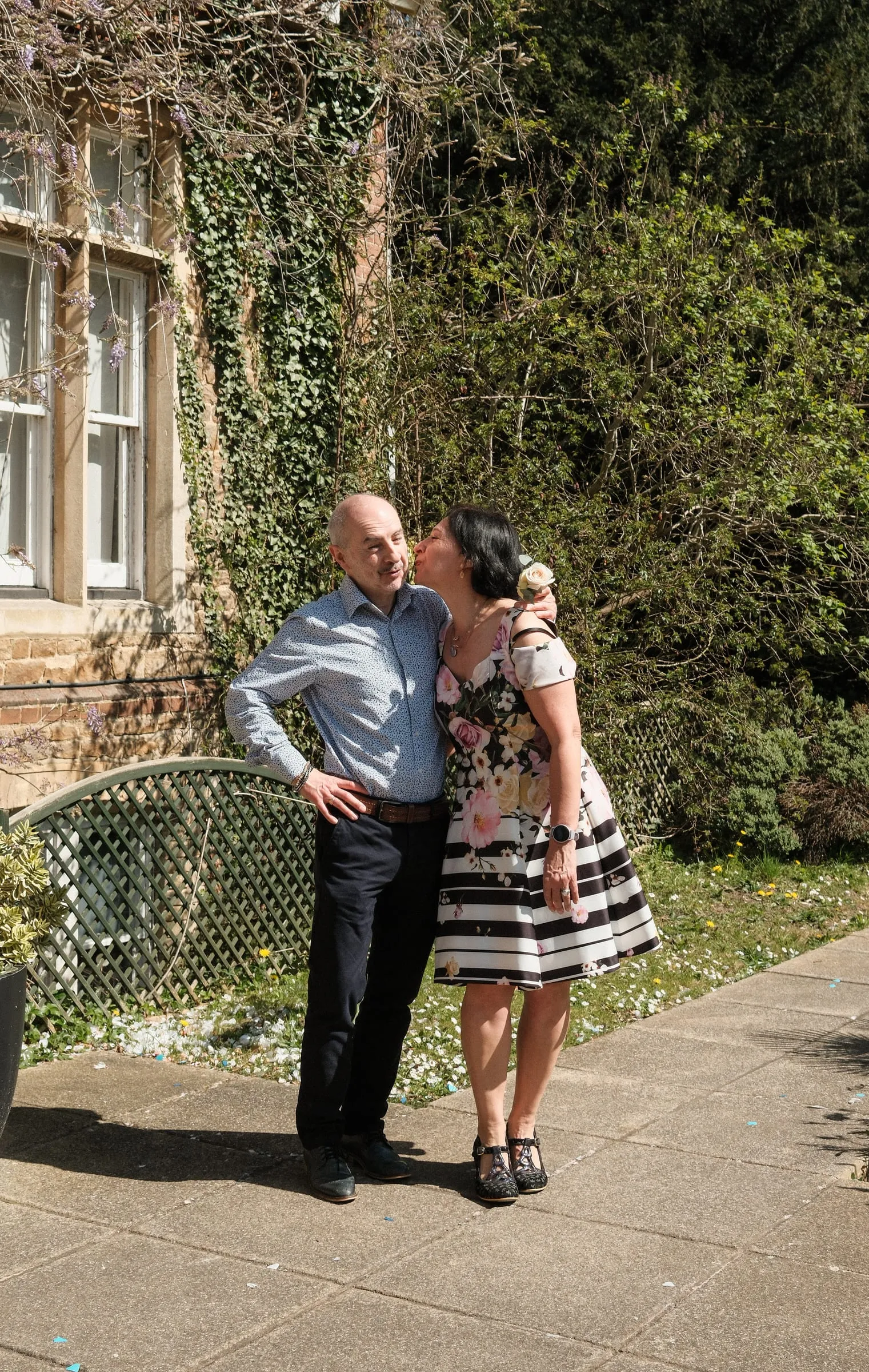 She kisses his cheek.